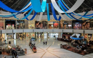 Large atrium at the Dubai Marina Mall with shops and cafes