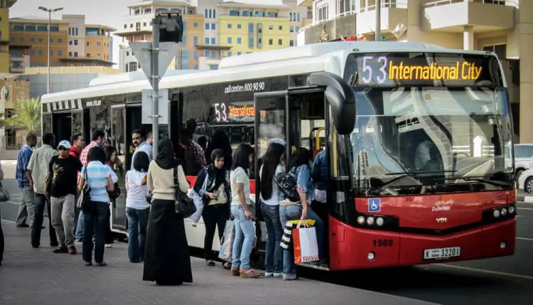 Immigrant workers boarding a bus to International City in Dubai
