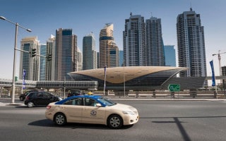 Taxi passing a Metro station on Sheikh Zayed Road in Dubai
