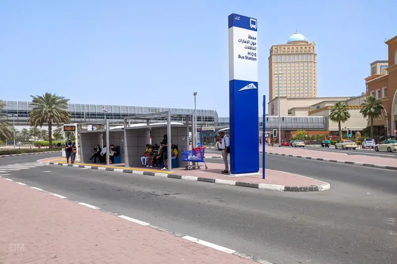Passengers waiting for a bus at Mall of the Emirates Bus Station, Dubai