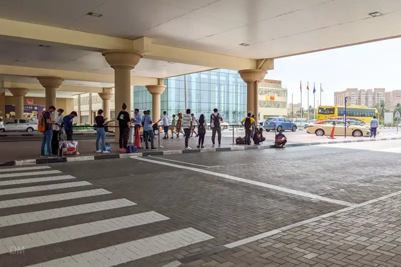 Passengers waiting for bus to Abu Dhabi at Ibn Battuta Bus Station