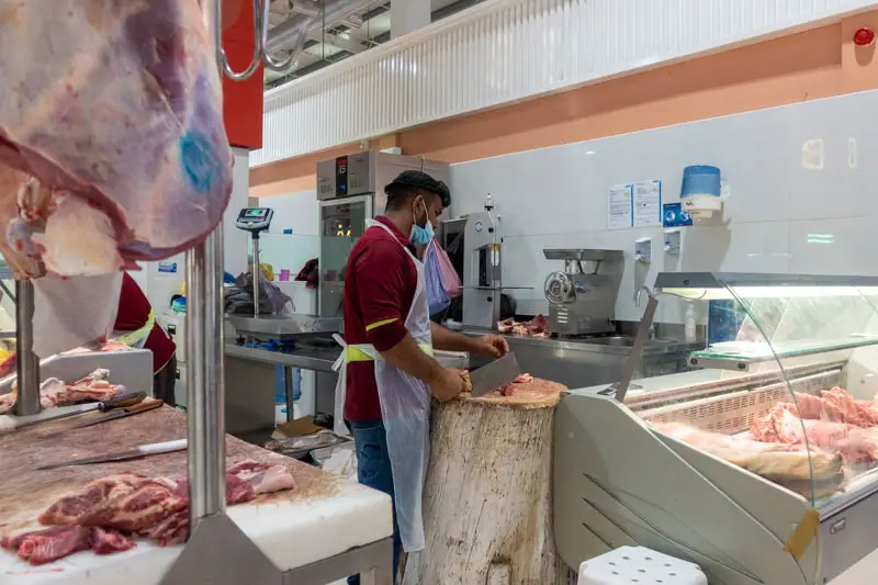 Worker cutting meat at the Waterfront Market, Dubai
